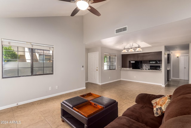 living room featuring tile floors, high vaulted ceiling, and ceiling fan