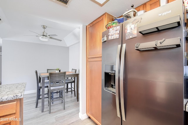 kitchen featuring stainless steel fridge with ice dispenser, light hardwood / wood-style floors, and ceiling fan