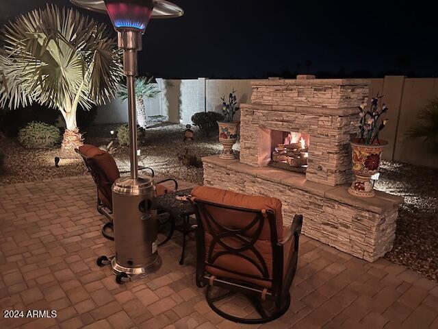 patio at night with an outdoor stone fireplace