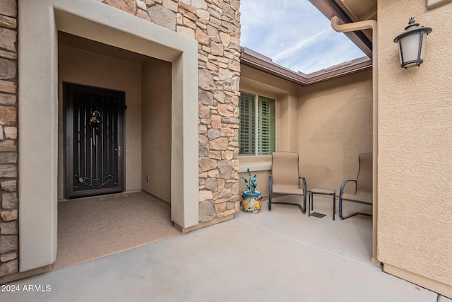 entrance to property with a patio