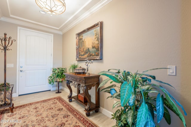 foyer entrance featuring light tile patterned floors and ornamental molding