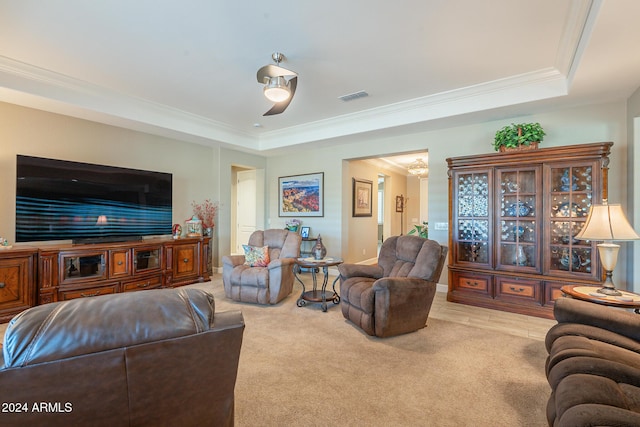 living room featuring a raised ceiling, light carpet, and crown molding