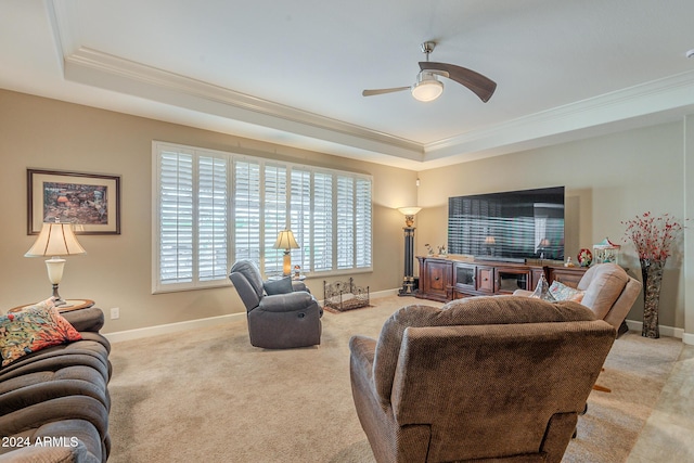 living room featuring ceiling fan, light colored carpet, and crown molding