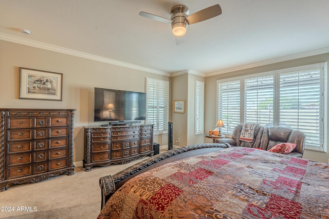 carpeted bedroom with ceiling fan and ornamental molding