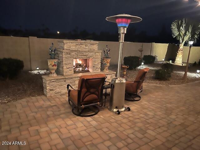 view of patio with an outdoor stone fireplace