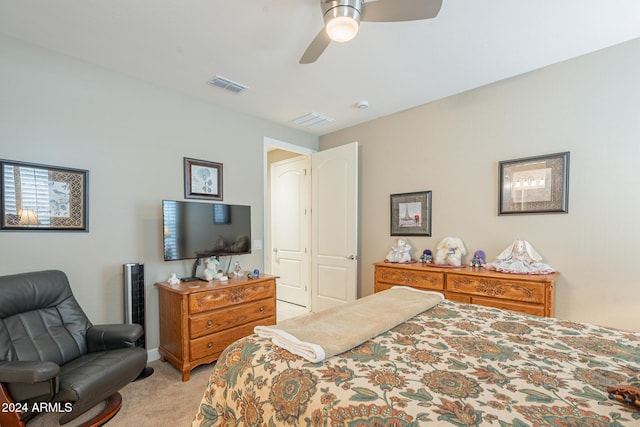 carpeted bedroom featuring ceiling fan and a closet