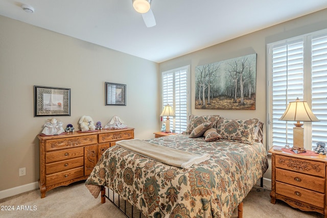 bedroom featuring light carpet and ceiling fan