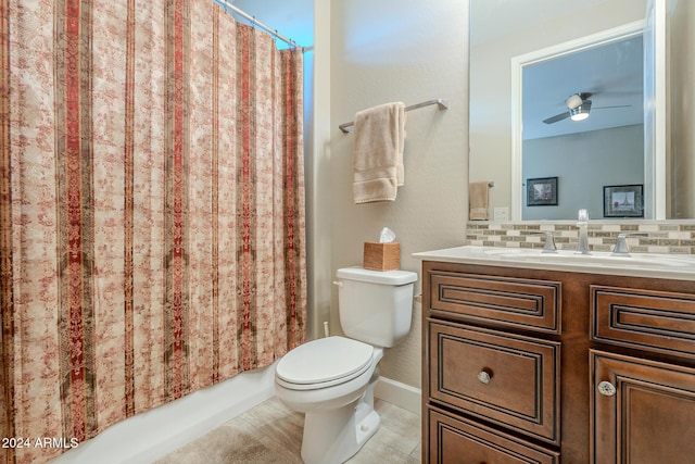 bathroom with backsplash, ceiling fan, vanity, and toilet