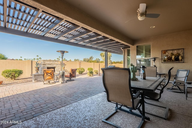 view of patio / terrace with ceiling fan and an outdoor stone fireplace