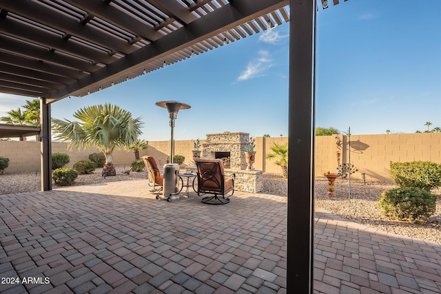 view of patio / terrace featuring an outdoor stone fireplace