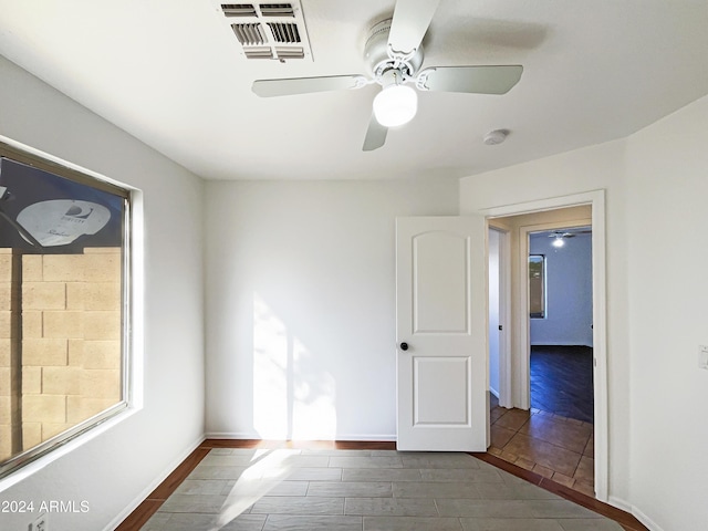 spare room featuring ceiling fan and dark wood-type flooring