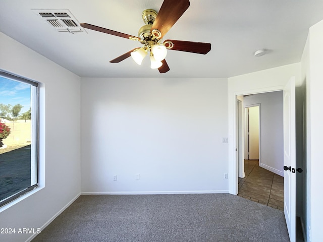 unfurnished room featuring carpet flooring and ceiling fan