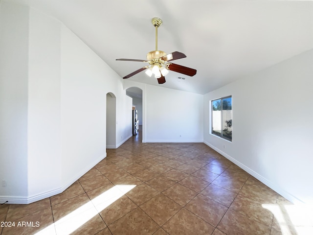 tiled empty room featuring ceiling fan