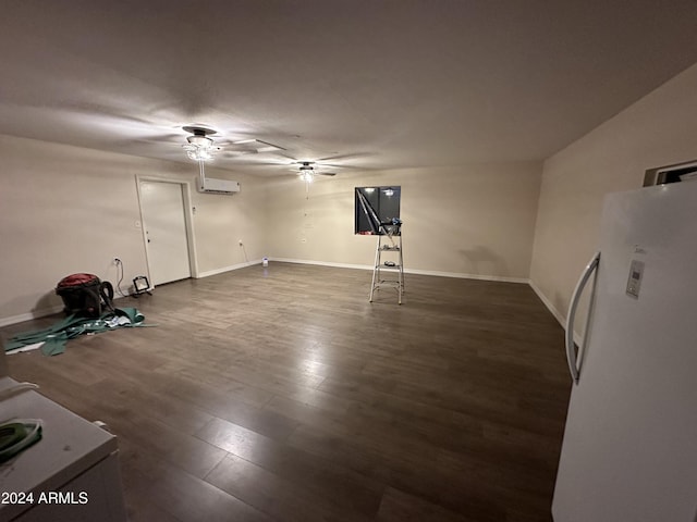 unfurnished room featuring ceiling fan, dark wood-type flooring, and a wall unit AC