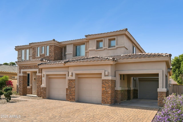 5557 W Mine Trl, Phoenix, AZ 85083 - view of front of property featuring stone siding, a garage, stucco siding, and decorative driveway