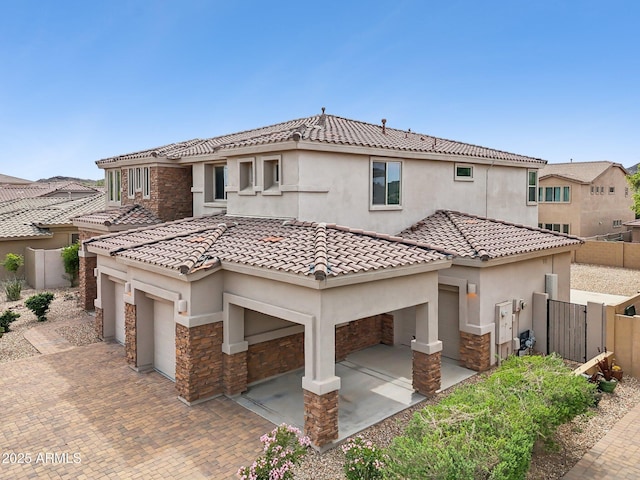 5557 W Mine Trl, Phoenix, AZ 85083 - view of front of property with stone siding, stucco siding, decorative driveway, and a tile roof