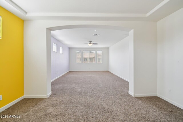 5557 W Mine Trl, Phoenix, AZ 85083 - spare room with arched walkways, carpet, a ceiling fan, and baseboards