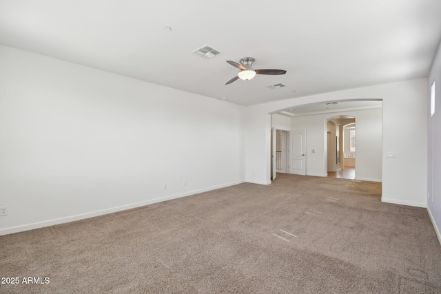5557 W Mine Trl, Phoenix, AZ 85083 - spare room featuring a ceiling fan, arched walkways, light colored carpet, and baseboards