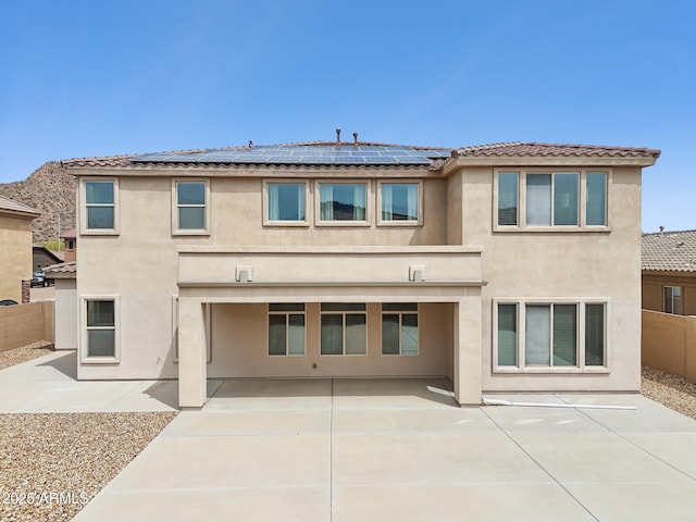 5557 W Mine Trl, Phoenix, AZ 85083 - rear view of house with a patio, stucco siding, and roof mounted solar panels