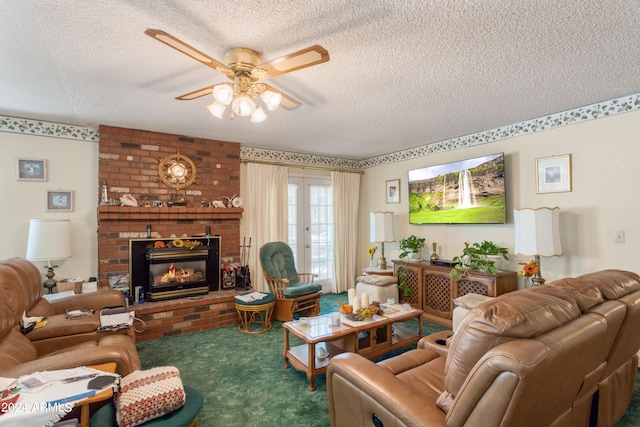 carpeted living room featuring ceiling fan, a fireplace, a textured ceiling, and french doors