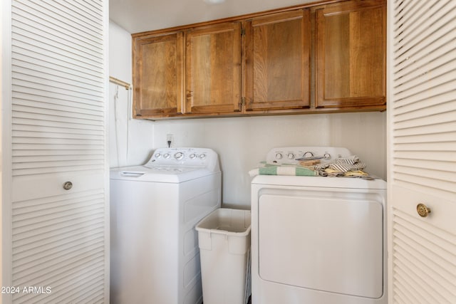 laundry room featuring cabinets and separate washer and dryer