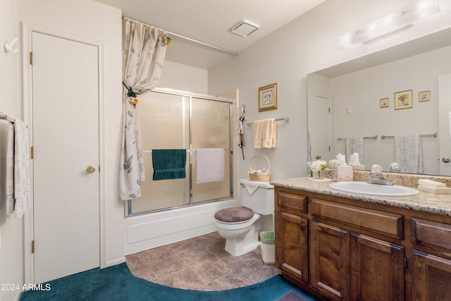 full bathroom with vanity, enclosed tub / shower combo, and toilet