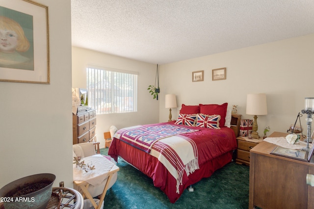 bedroom with a textured ceiling and dark colored carpet