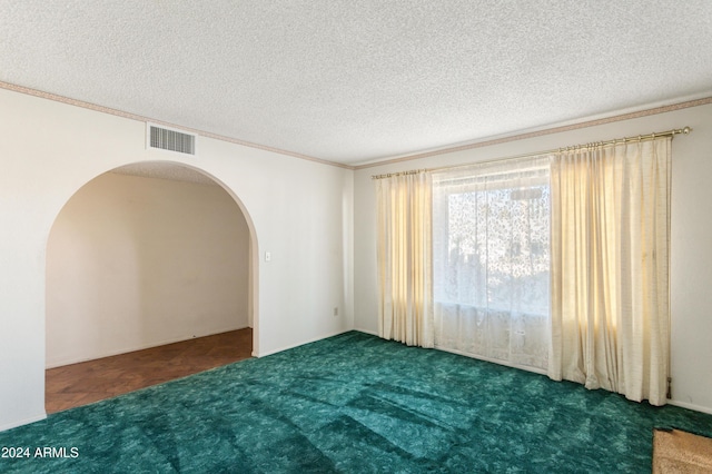 carpeted spare room featuring crown molding and a textured ceiling