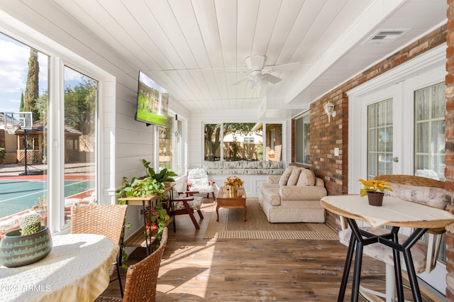 sunroom / solarium with ceiling fan, french doors, and wooden ceiling