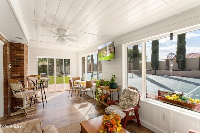 sunroom / solarium featuring ceiling fan and wood ceiling