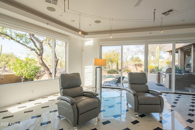 sunroom featuring a tray ceiling