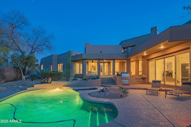 view of swimming pool featuring a patio and area for grilling