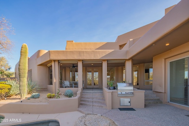 exterior space with exterior kitchen, a patio, and french doors