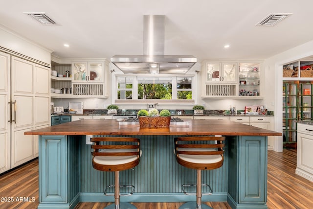 kitchen with visible vents, open shelves, island exhaust hood, and butcher block counters