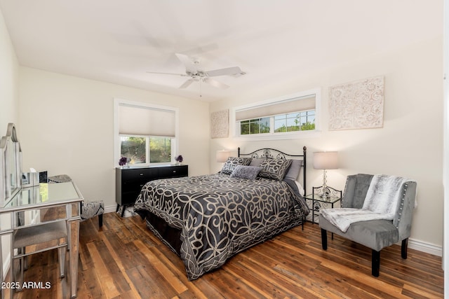 bedroom featuring hardwood / wood-style floors, a ceiling fan, and baseboards