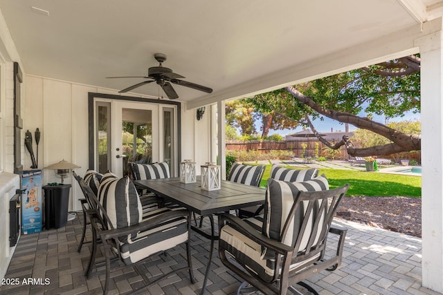 view of patio featuring a fenced in pool, outdoor dining area, a ceiling fan, and a fenced backyard