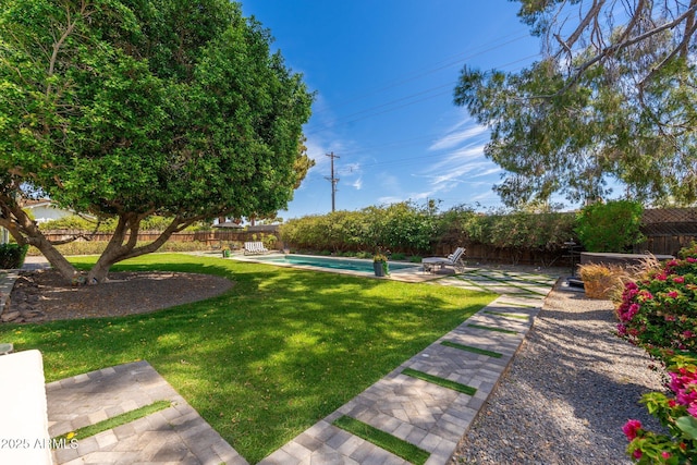 view of yard featuring a patio, a fenced in pool, and a fenced backyard