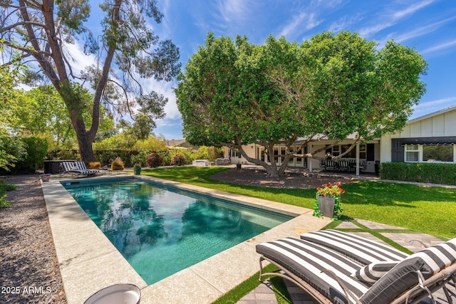 pool featuring a patio and a yard
