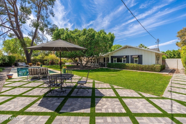 exterior space with a patio, fence, and an outdoor pool