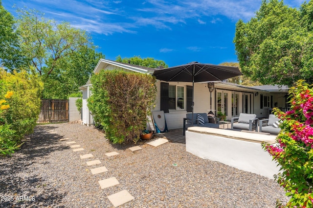 rear view of house featuring a patio, fence, and an outdoor hangout area