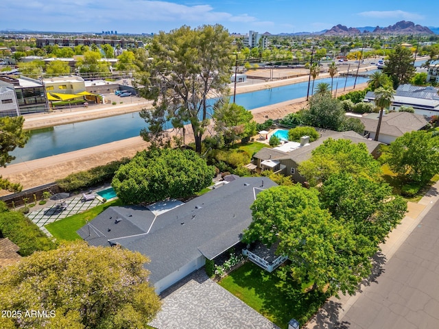 drone / aerial view featuring a residential view and a water view