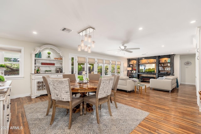 dining area with ceiling fan, visible vents, baseboards, french doors, and wood finished floors