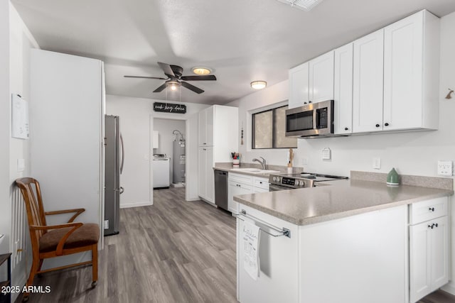 kitchen with sink, stainless steel appliances, and white cabinets