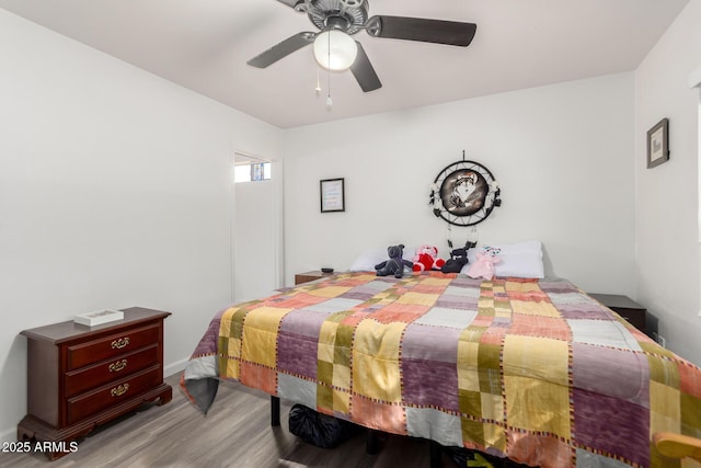 bedroom with ceiling fan and light hardwood / wood-style floors