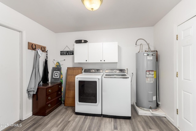 laundry room featuring light hardwood / wood-style floors, cabinets, separate washer and dryer, and electric water heater