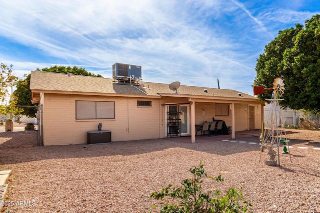 rear view of property featuring a patio and central air condition unit