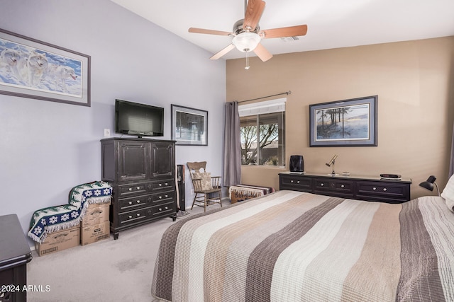 bedroom with vaulted ceiling, light carpet, and ceiling fan