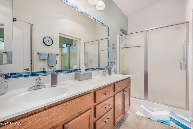 bathroom featuring vanity, tile patterned flooring, an enclosed shower, and lofted ceiling