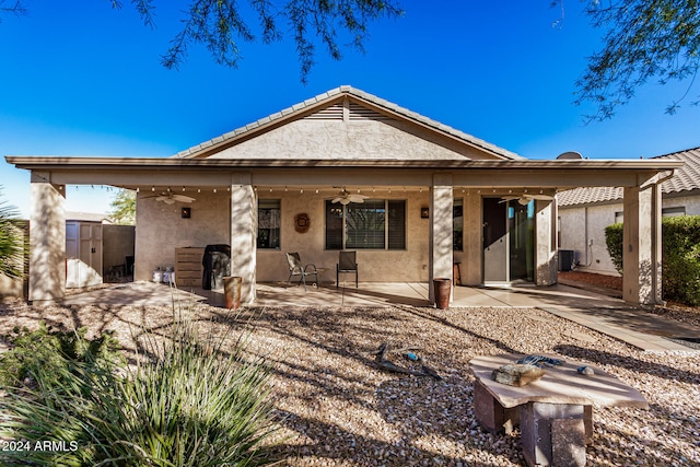 rear view of house featuring central air condition unit, ceiling fan, and a patio area