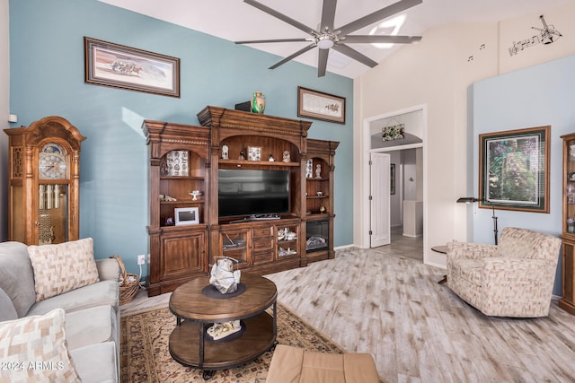 living room featuring built in features, high vaulted ceiling, wood-type flooring, and ceiling fan